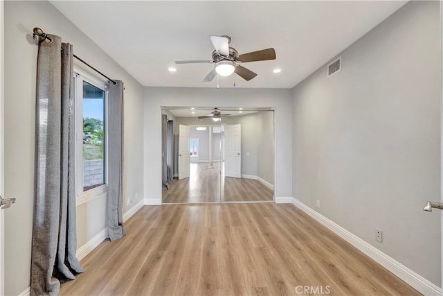 empty room with light hardwood / wood-style flooring and ceiling fan