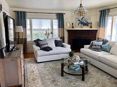 living room with a chandelier and wood-type flooring