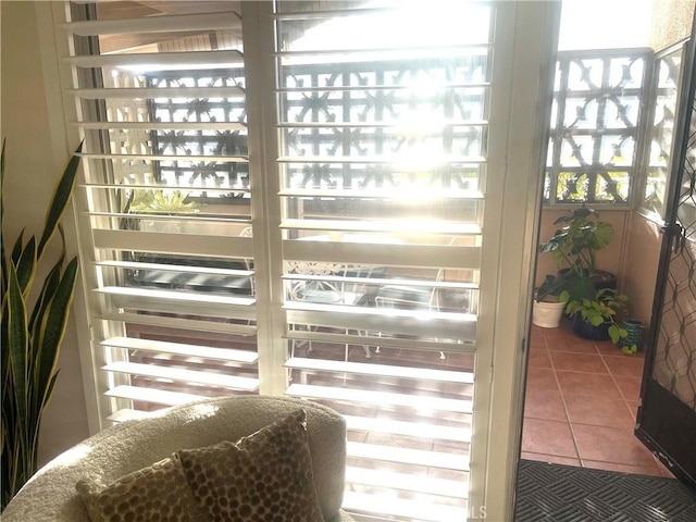 doorway to outside with tile patterned flooring