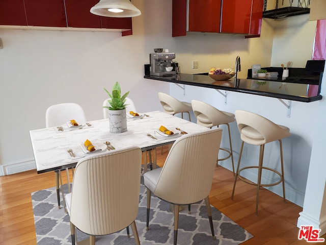 interior space with hardwood / wood-style flooring and a kitchen breakfast bar