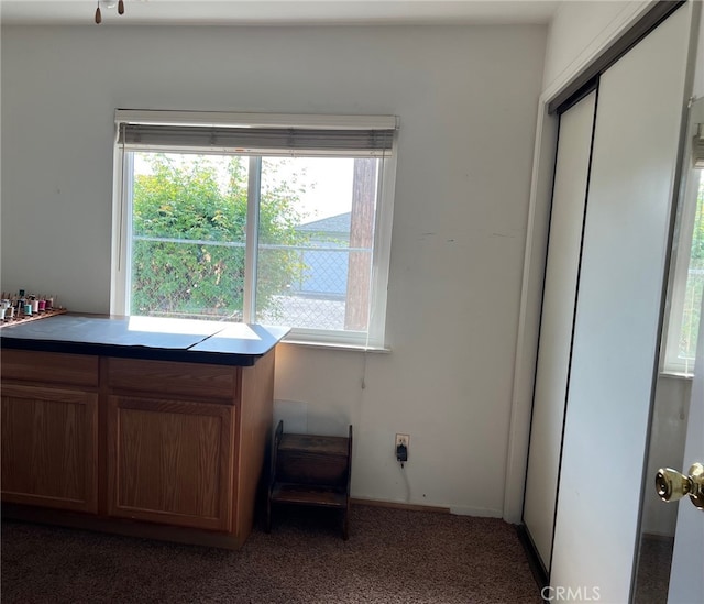 unfurnished office with dark colored carpet