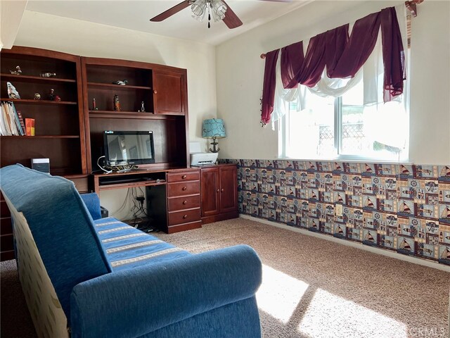 carpeted office space featuring ceiling fan