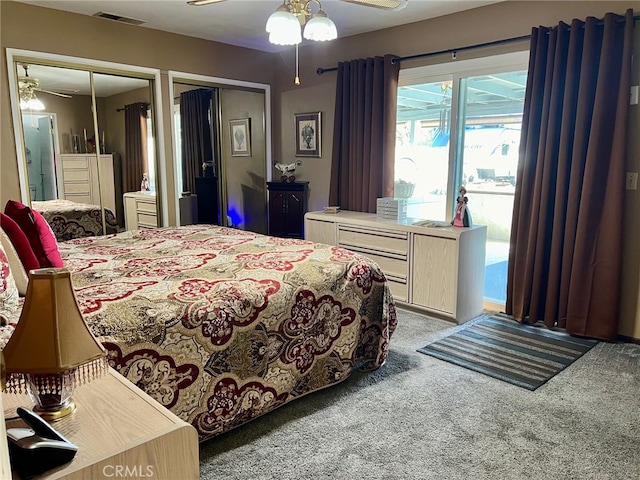 bedroom with multiple closets, light colored carpet, and ceiling fan