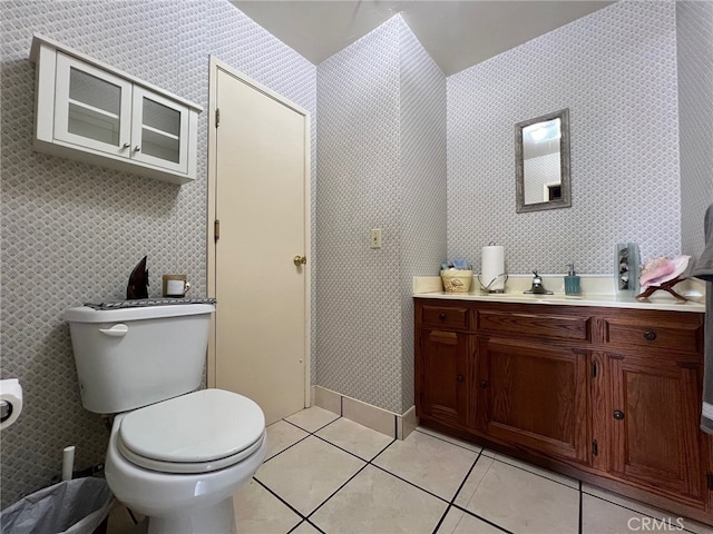 bathroom featuring toilet, vanity, and tile patterned flooring