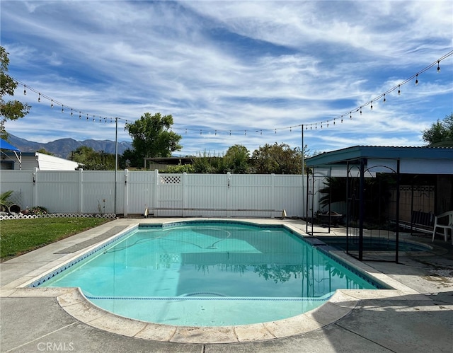 view of pool featuring a patio and a mountain view