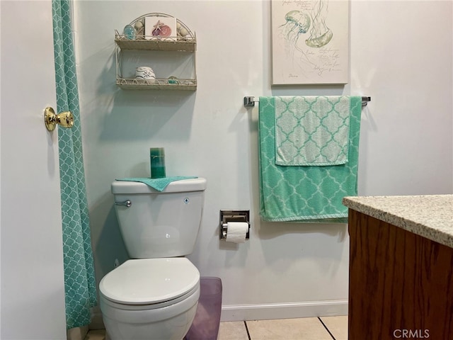 bathroom with vanity, toilet, and tile patterned flooring