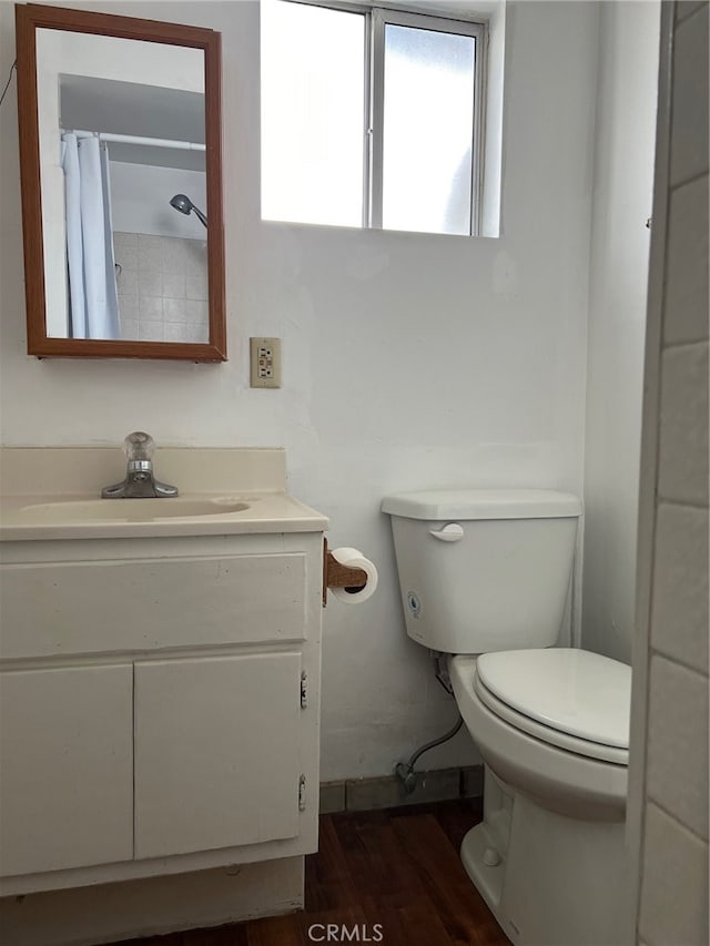 bathroom with vanity, hardwood / wood-style floors, a shower with curtain, and toilet