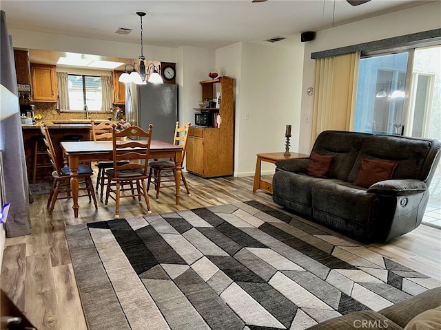 living room with hardwood / wood-style flooring and a chandelier