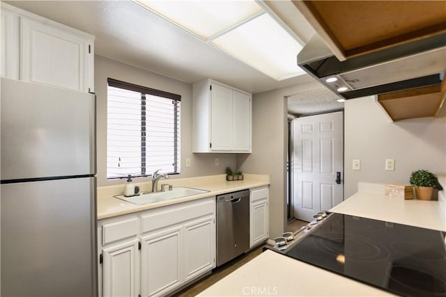 kitchen featuring appliances with stainless steel finishes, white cabinetry, and sink