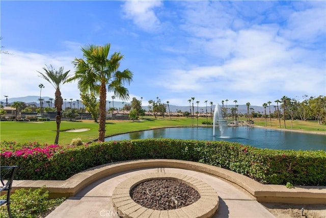 view of home's community with a lawn and a water view