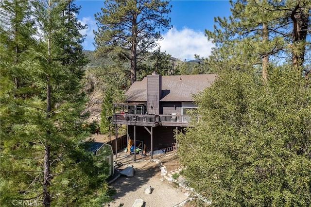 rear view of property featuring a wooden deck