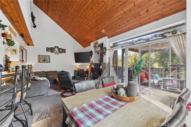 carpeted dining area with high vaulted ceiling and wooden ceiling