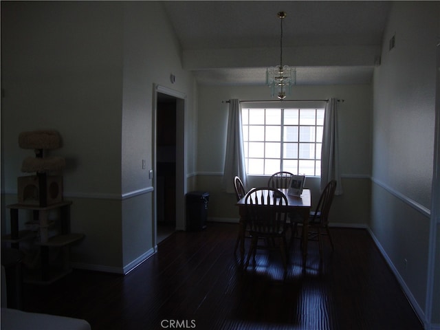 dining room with a chandelier and dark hardwood / wood-style floors