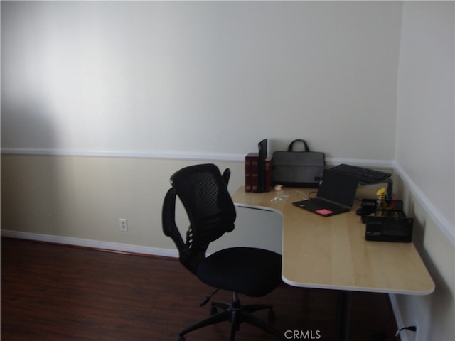 office space with dark wood-type flooring