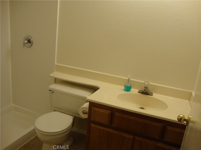 bathroom with vanity, toilet, and walk in shower