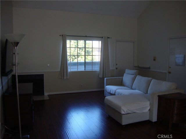 living room featuring vaulted ceiling and dark hardwood / wood-style flooring