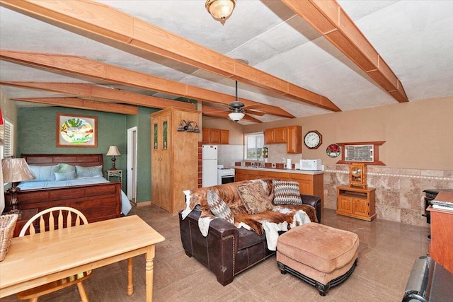 living room featuring beam ceiling, tile walls, and ceiling fan