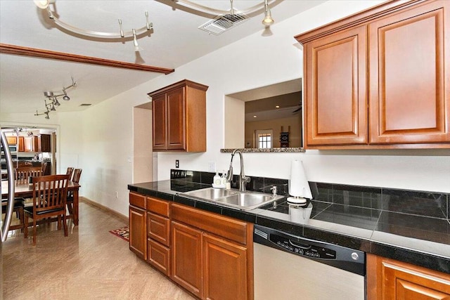 kitchen with sink, rail lighting, and dishwasher