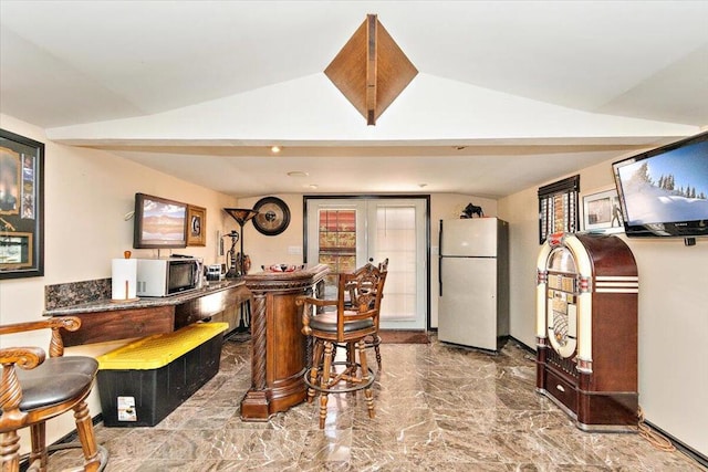 kitchen with french doors, vaulted ceiling, and white appliances