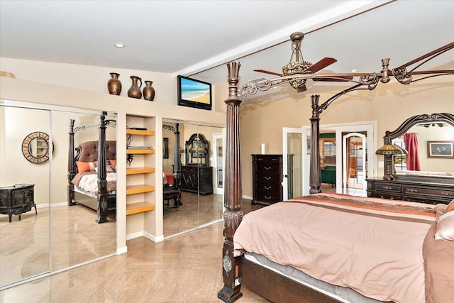 bedroom featuring two closets and ceiling fan