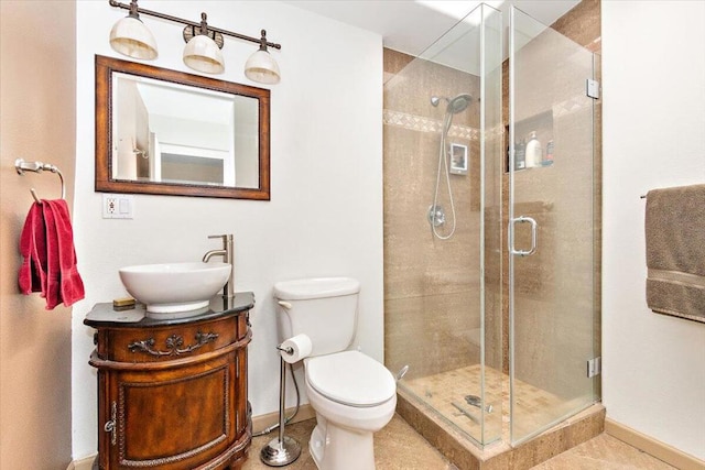 bathroom featuring vanity, tile patterned flooring, toilet, and an enclosed shower