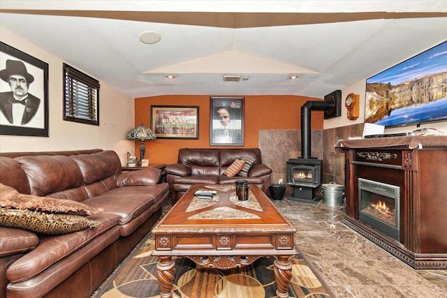 living room with lofted ceiling and a fireplace