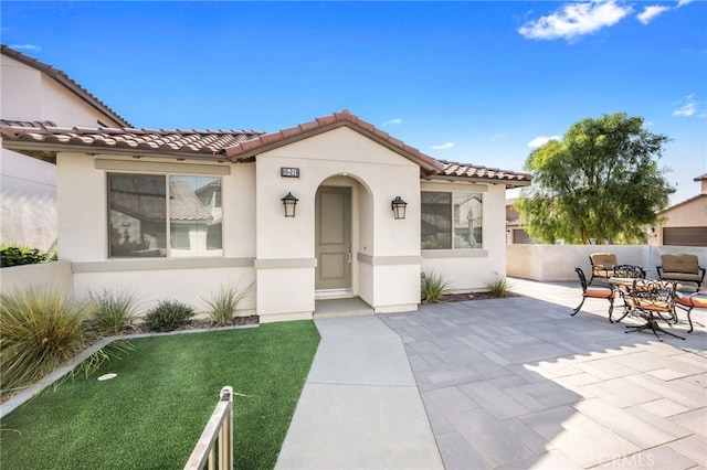 mediterranean / spanish-style home featuring a patio area