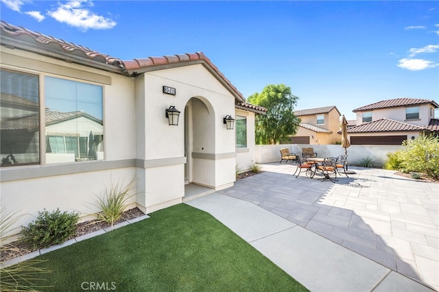 property entrance with a patio