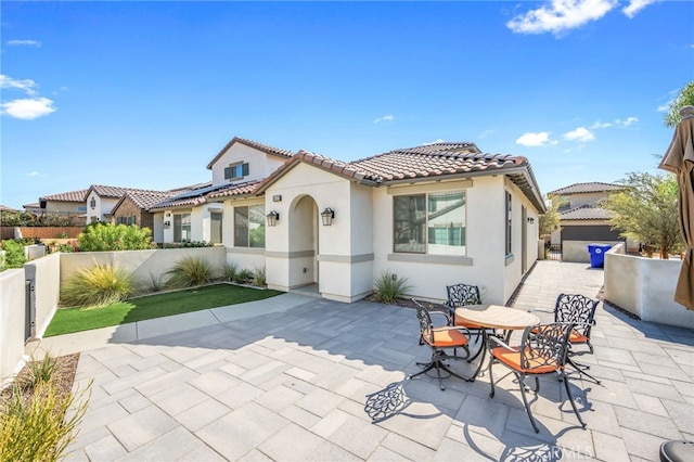 rear view of property featuring a patio area