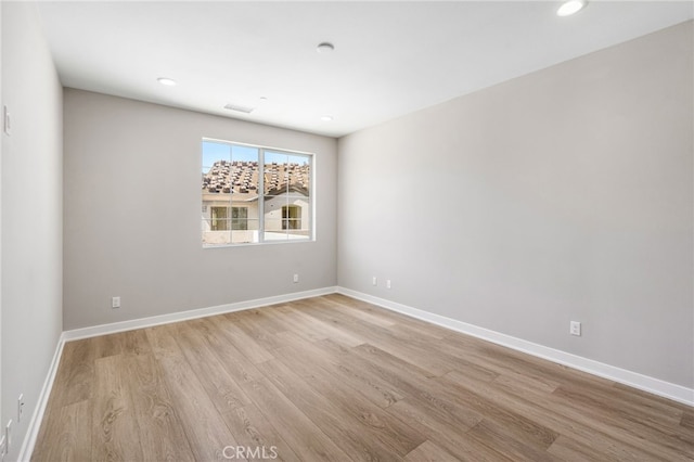 spare room featuring light hardwood / wood-style flooring