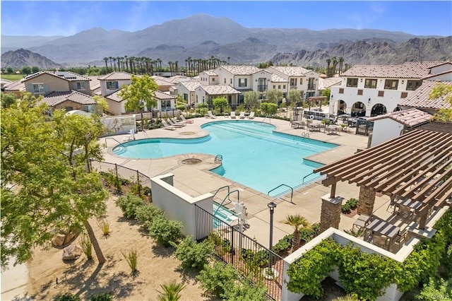 view of swimming pool featuring a mountain view and a patio area