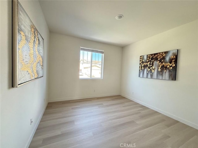 empty room with light hardwood / wood-style flooring