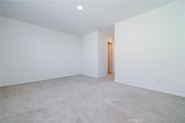 unfurnished room featuring light colored carpet