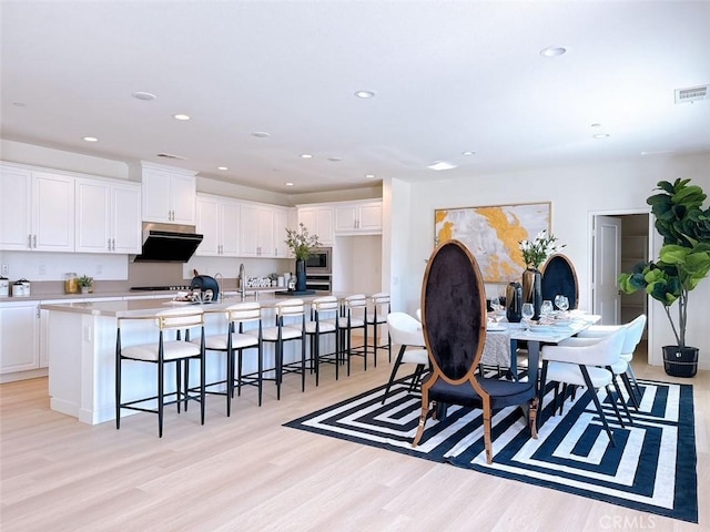 dining area with light wood-type flooring