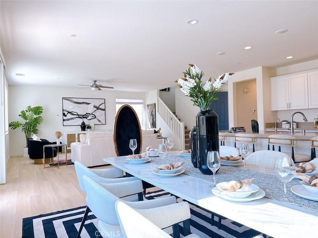 dining space featuring ceiling fan and light hardwood / wood-style floors