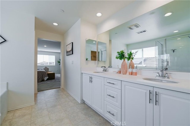 bathroom with vanity and a shower with shower door