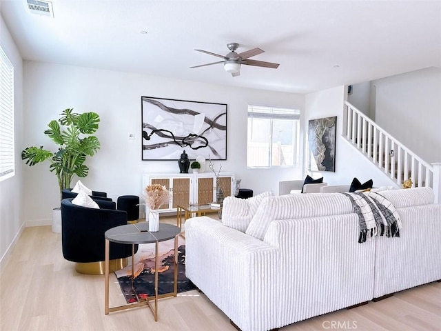 living room featuring ceiling fan and light wood-type flooring