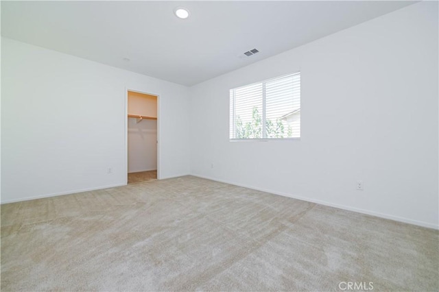 spare room with light colored carpet