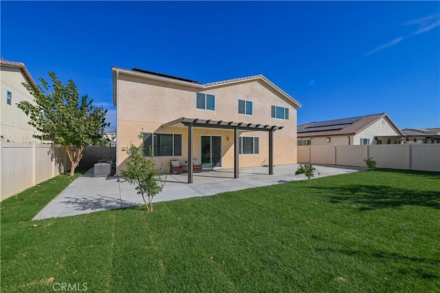 rear view of property featuring cooling unit, a yard, and a patio