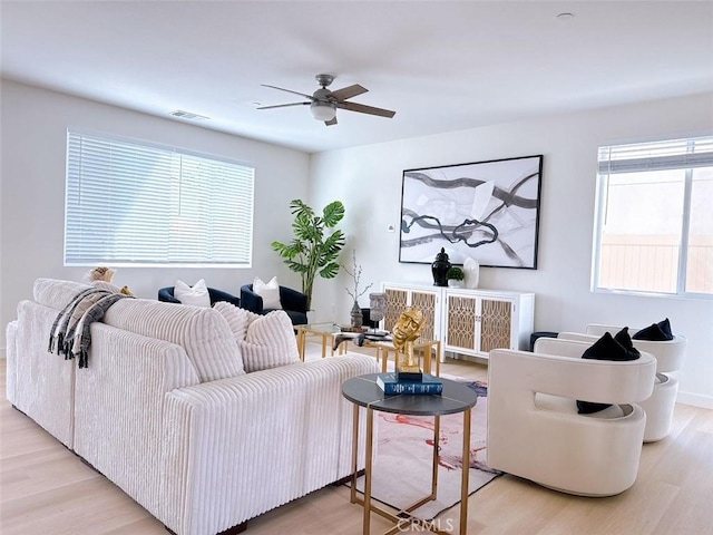 living room featuring ceiling fan, a healthy amount of sunlight, and light hardwood / wood-style flooring