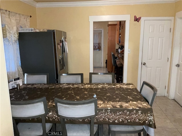 dining area with ornamental molding and light tile patterned floors