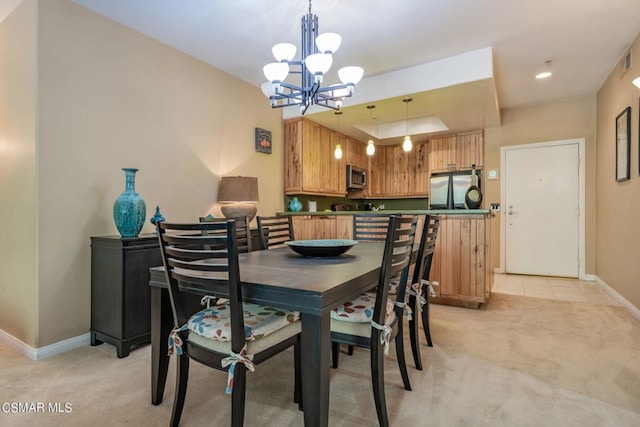 dining space with a notable chandelier and light colored carpet