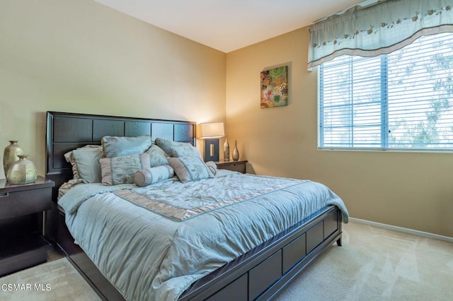 bedroom featuring light carpet