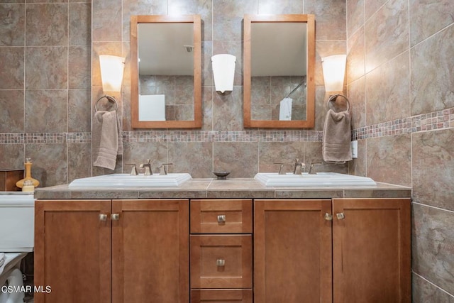 bathroom with vanity, tasteful backsplash, and tile walls