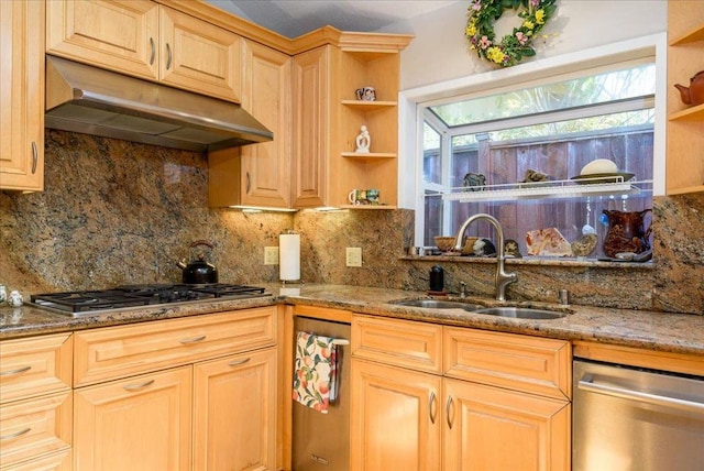 kitchen with sink, appliances with stainless steel finishes, dark stone countertops, backsplash, and light brown cabinetry