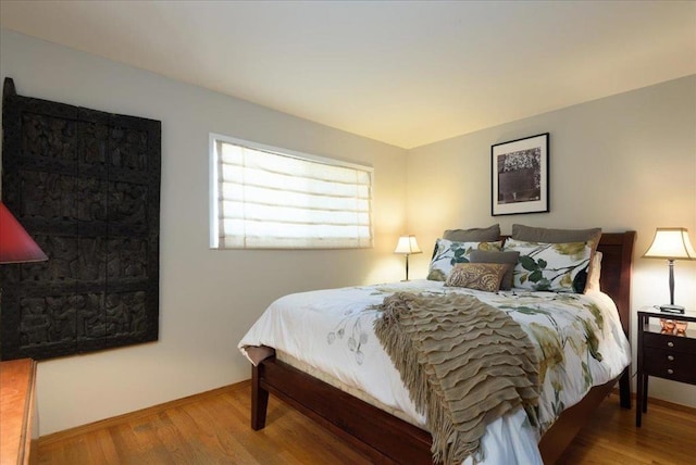 bedroom with hardwood / wood-style flooring