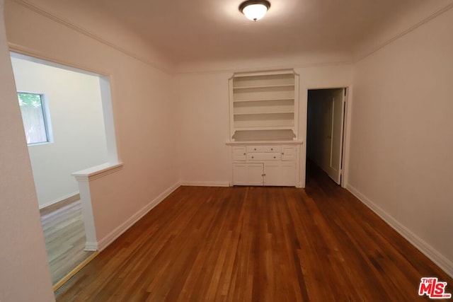 unfurnished bedroom featuring dark hardwood / wood-style flooring