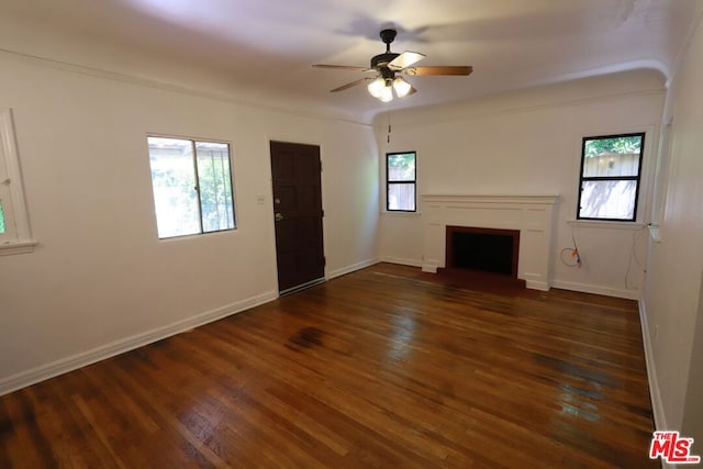 unfurnished living room featuring ceiling fan, ornamental molding, and dark hardwood / wood-style floors