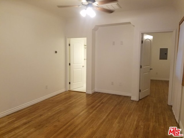 unfurnished bedroom featuring ceiling fan, wood-type flooring, and electric panel