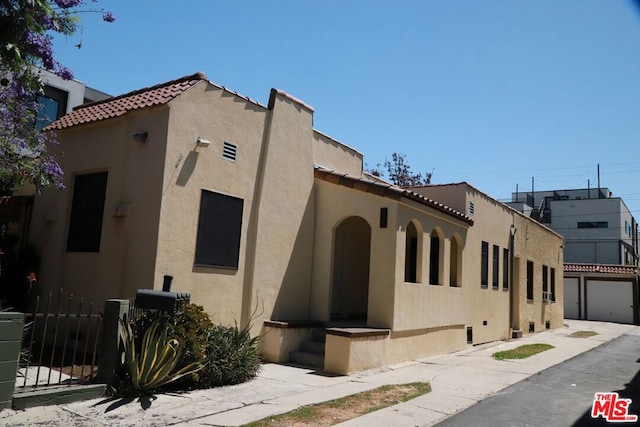 view of side of property with a garage